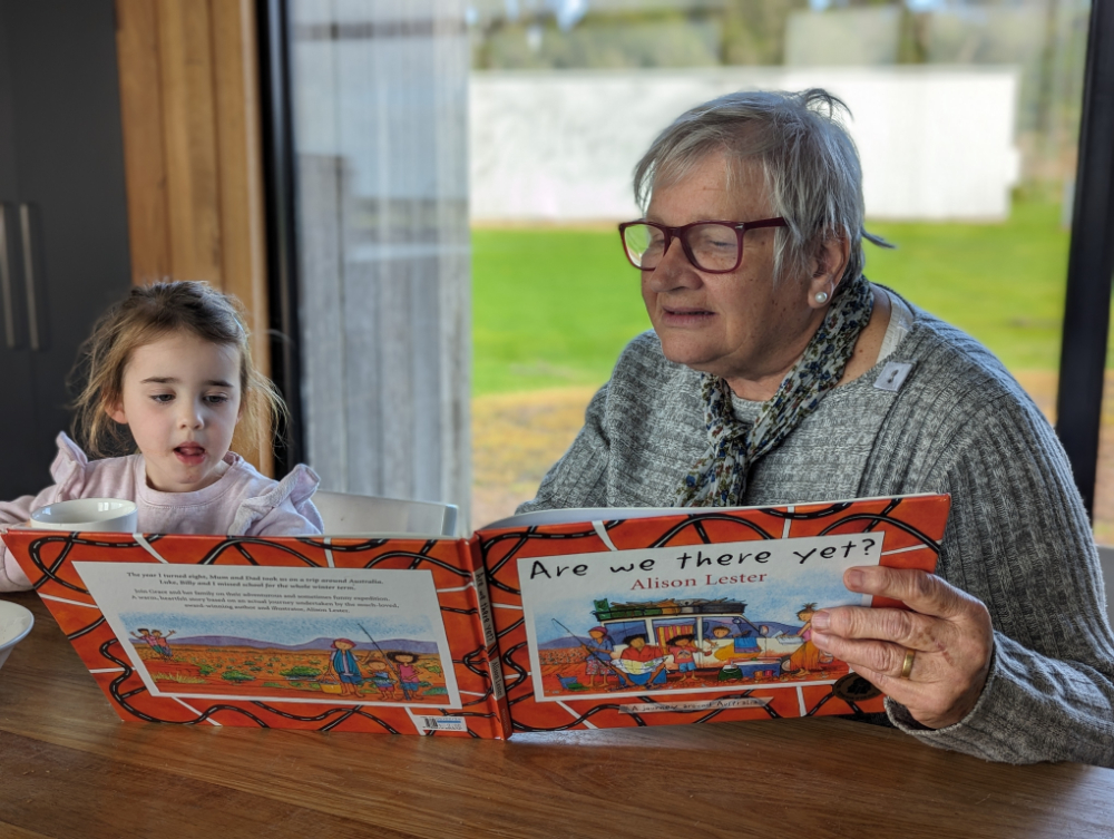 Reading books at the dining table of our Wilsons Prom accommodation