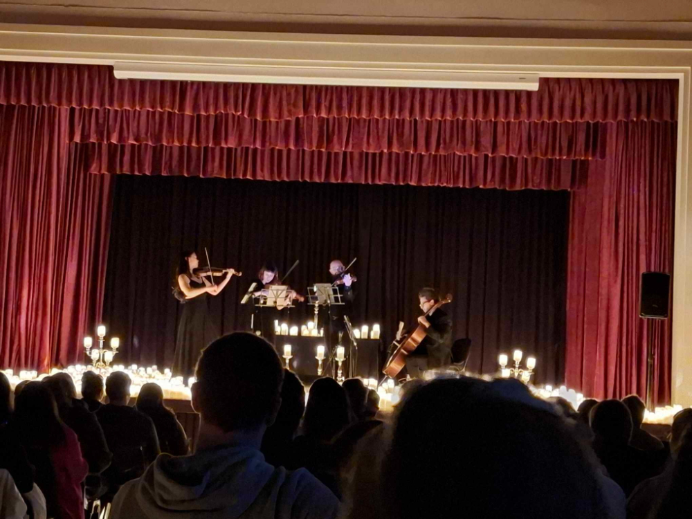 The stage with four musicians surrounded by candles for the Candlelight Concert Geelong