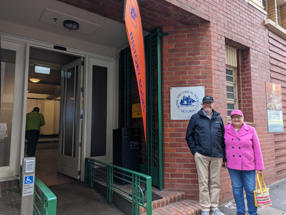 Two people stand at the entrance to the Royal Historical Society of Victoria
