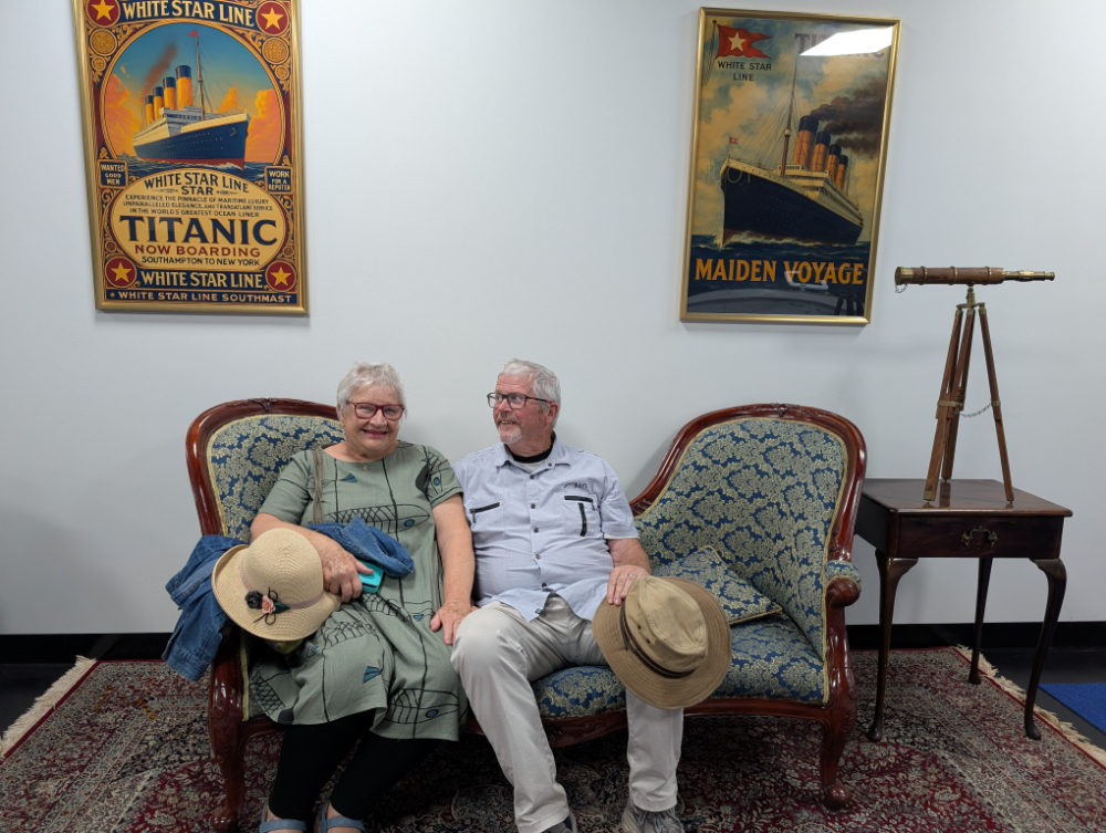 Two guests waiting on a lounge with Titanic memorabilia